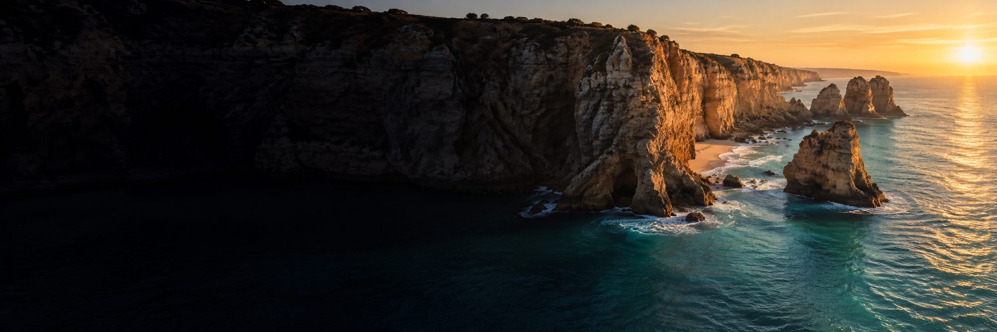 Golden cliffs and turquoise water on the Atlantic coast at sunset