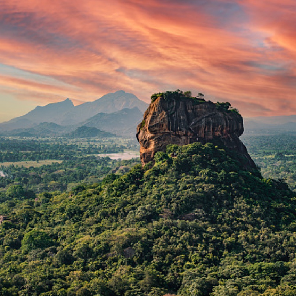 Sigiriya rock rising above the forest at sunset